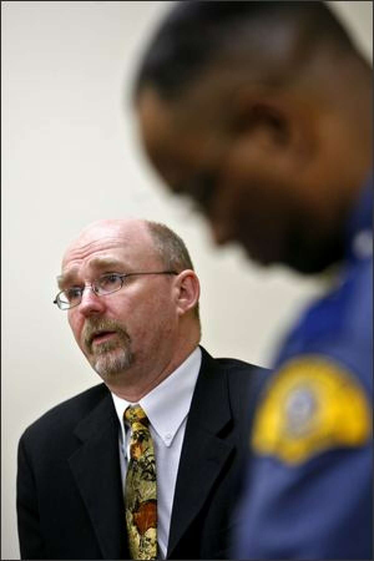 Barry Logan talks to the media Thursday about his crime lab resignation. At right is State Patrol Chief John Batiste.