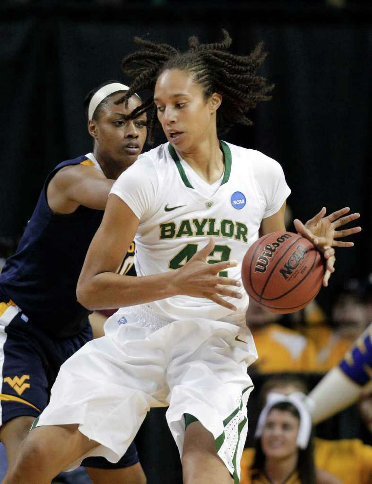 Baylor center Brittney Griner (42) looks for an opening against West Virginia center Asya Bussie, left, in the first half of a second-round game of the NCAA women's college basketball tournament Tuesday, March 22, 2011, in Waco, Texas.