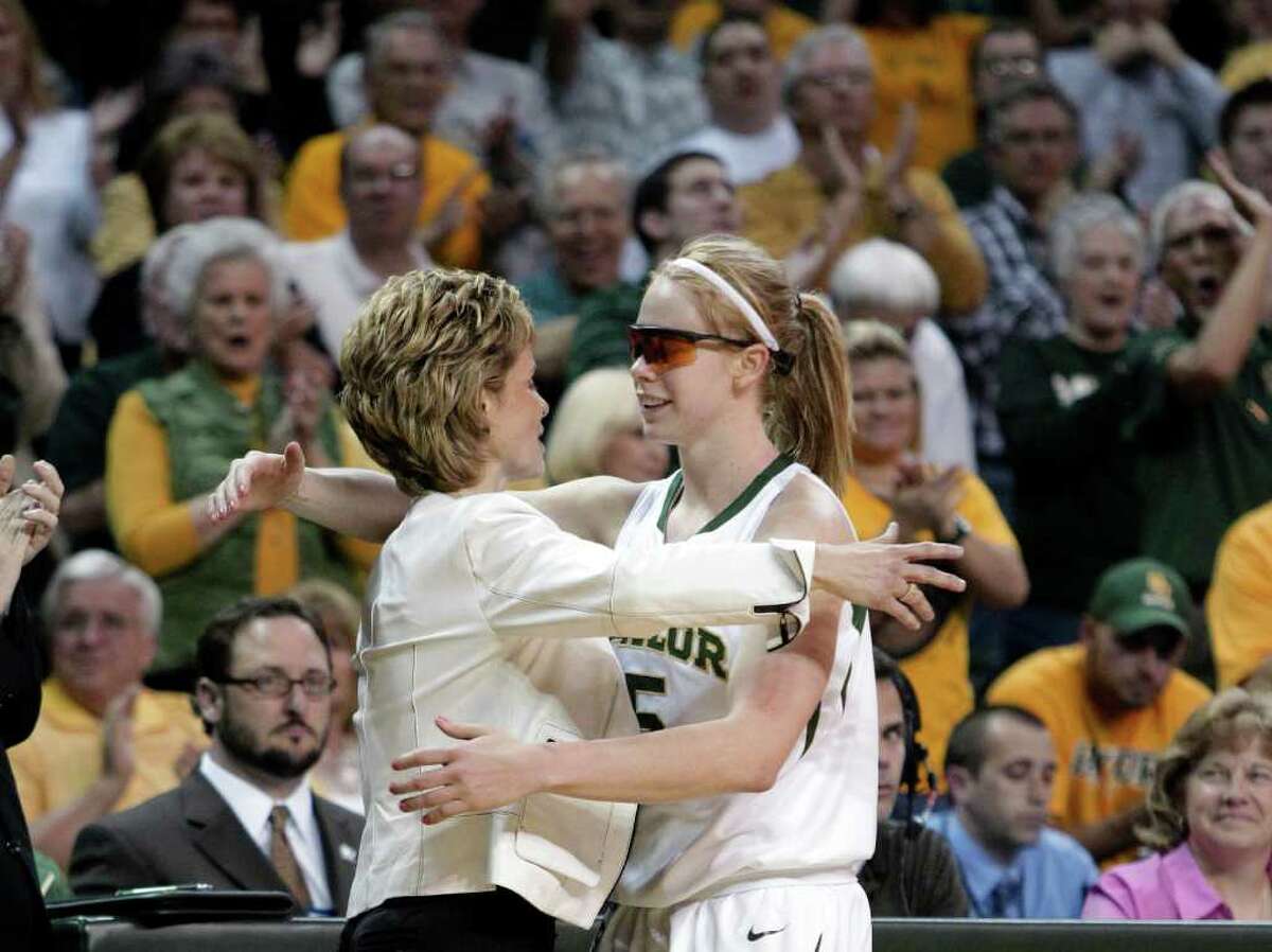 Baylor coach Kim Mulkey, left, gives guard Melissa Jones a hug as Jones receives a standing ovation from fans late in the second half of a second-round game against West Virginia in the NCAA women's college basketball tournament Tuesday, March 22, 2011, in Waco, Texas. Jones, a senior, played her final home game in the 82-68 win over West Virginia.