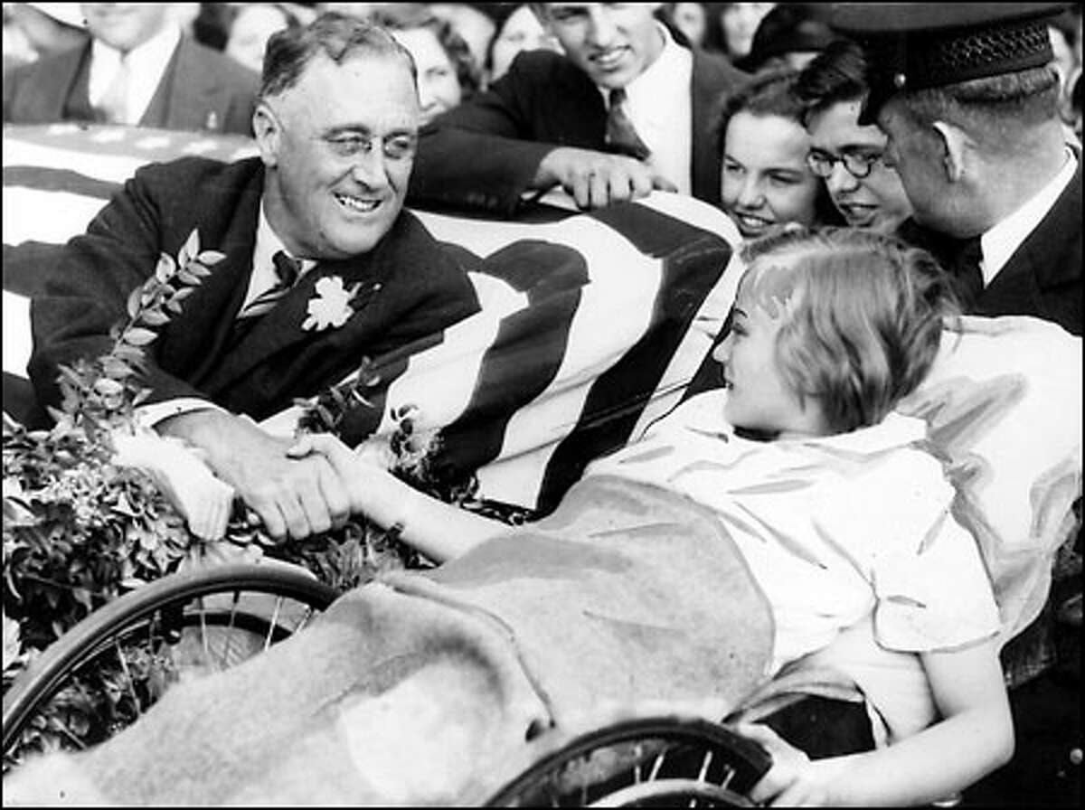 Franklin D. Roosevelt campaigns in Seattle, clasping the hand of Melody Bresina at Children’s Orthopedic Hospital on Sept. 20, 1932. Roosevelt was in a wheelchair but he got around.  As President, he would visit Port Angeles, Lake Crescent and Lake Quinault -- a visit that would give us (and America) the Olympic NationaL Park.