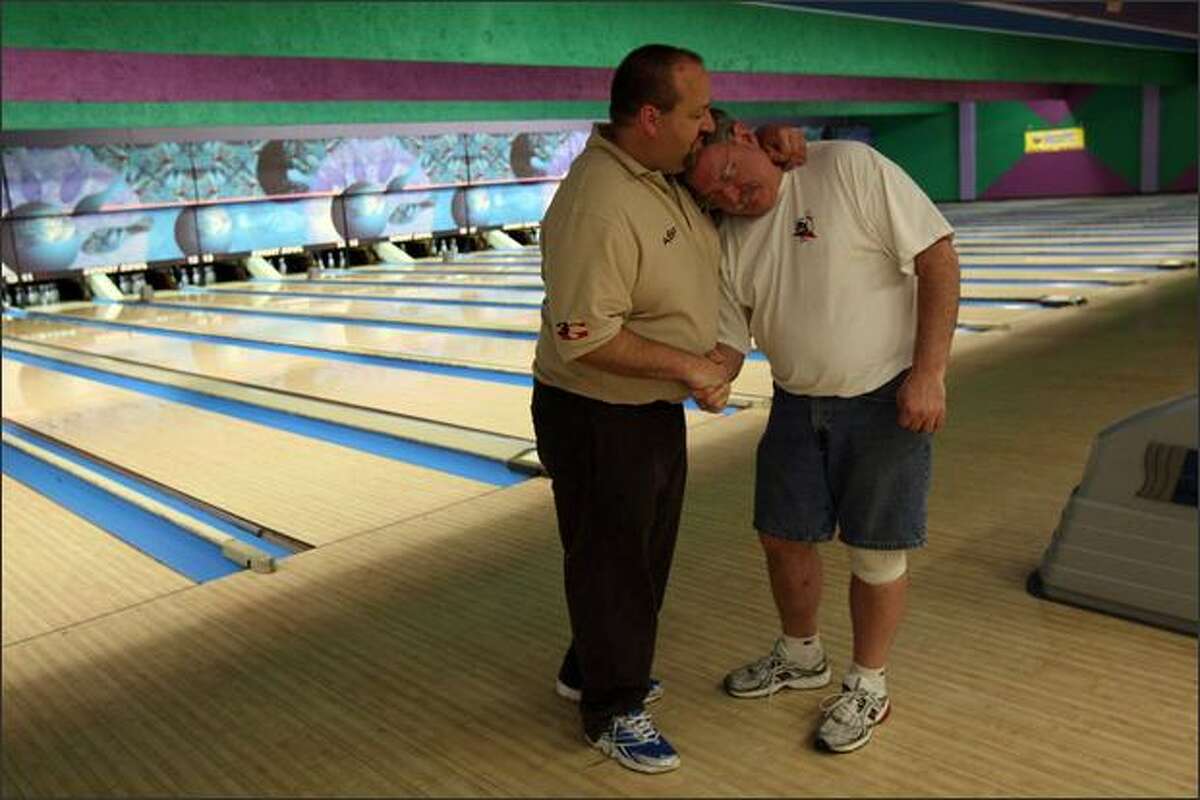 Roy Lynch, right, and Bob Davidson share a moment as their time at Sunset Bowl comes to an end Sunday. Lynch's memories there include proposing to his first wife. Davidson's father once managed the business: "I grew up here."