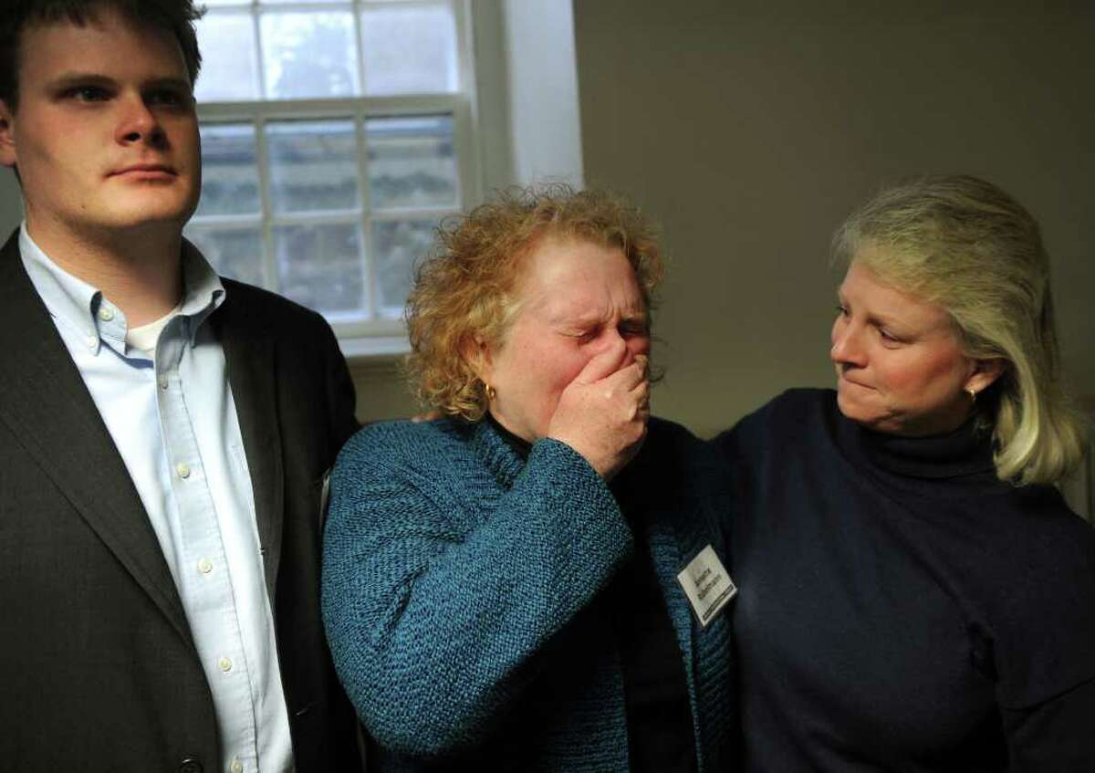 Orange Congregational Church Deacon Annette Rubelmann, center, sobs with joy after hearing the announcement that the missing girl, Isabella Oleschuk, had been found unharmed. The news was announced at a press conference at the church on Wednesday, March 23, 2011. From left are church pastor's son Stuart King, Rubellmann, and church youth director Beth Rafferty.