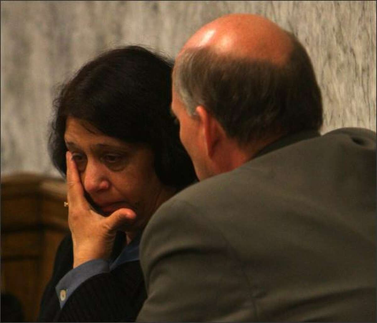 Naveed Haq's mother, Nahida Haq, consults defensive attorney C. Wesley Richards after testifying on behalf of her son, who is on trial for the shootings at the Jewish Federation of Greater Seattle.