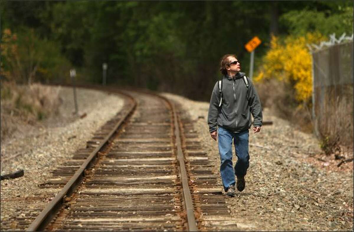 Robert Manzlak walks to work Monday from the South Kirkland park and ride along the Eastside rail corridor, which Manzlak has used for his work commute since 2003.