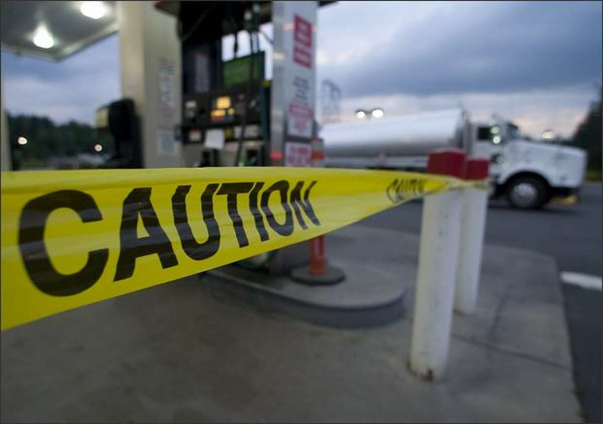 Yellow caution tape warns motorists not to use the gas pumps at the Safeway Gas Station at 27020 Maple Valley Highway Sunday. A number of cars stalled out after purchasing contaminated fuel from the station.