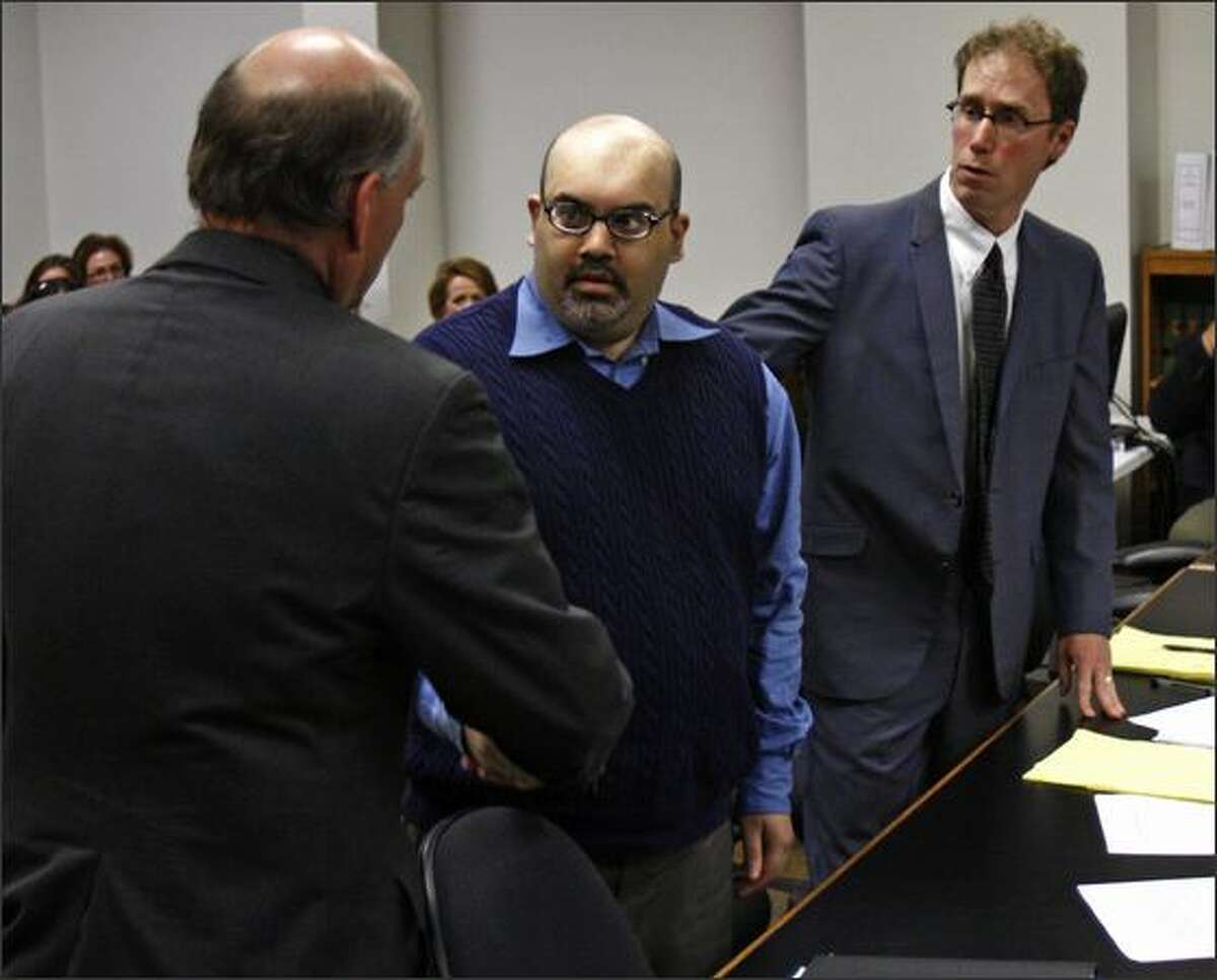 Naveed Haq shakes hands with his attorney, C. Wesley Richards, after a mistrial was declared in his case Wednesday. Haq faced 15 criminal charges including aggravated murder as well as attempted murder, kidnapping, burglary, unlawful imprisonment and hate-crime charges.