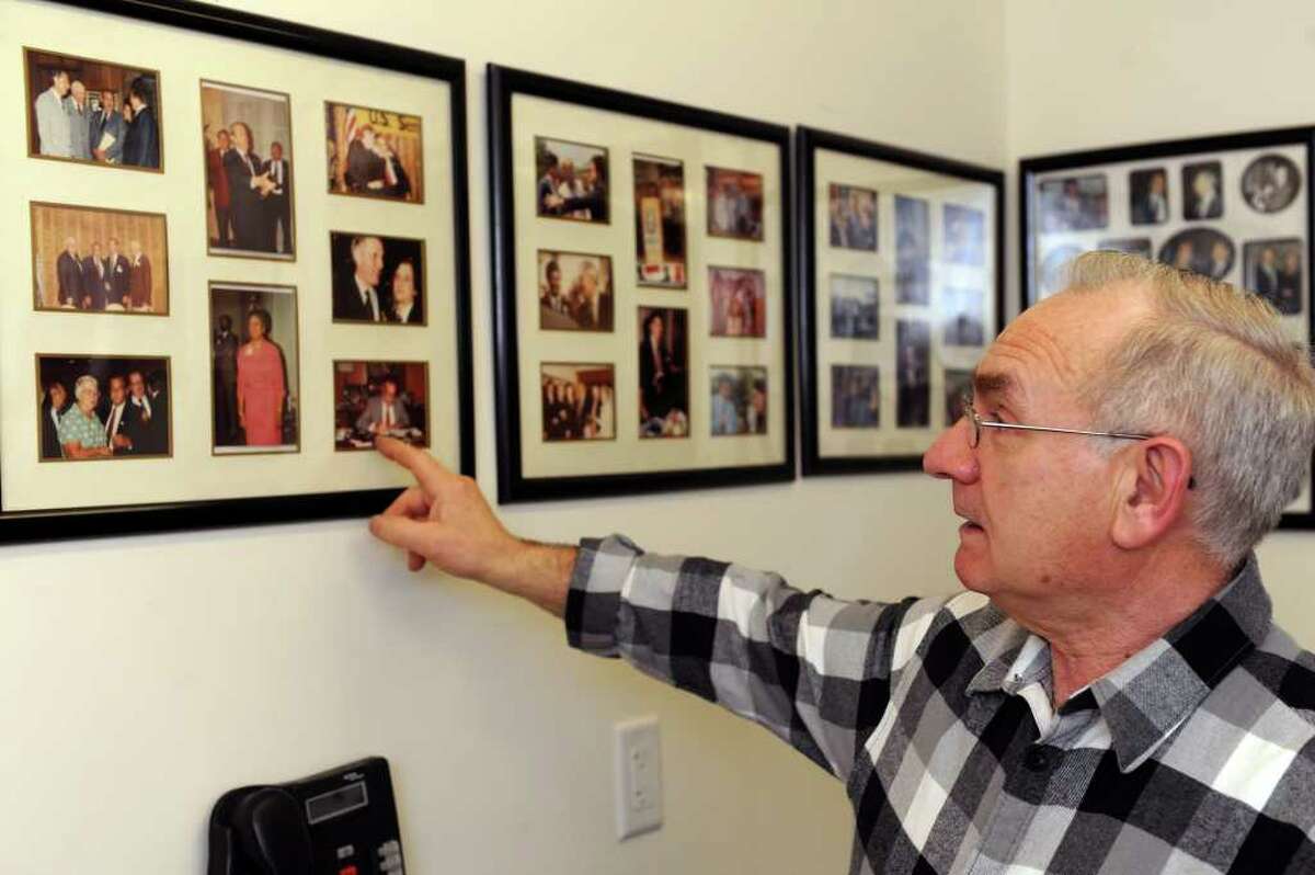 Mario Testa looks at photos of politicians on the wall of his office at Testo's restaurant in Bridgeport on Tuesday, March 22, 2011.