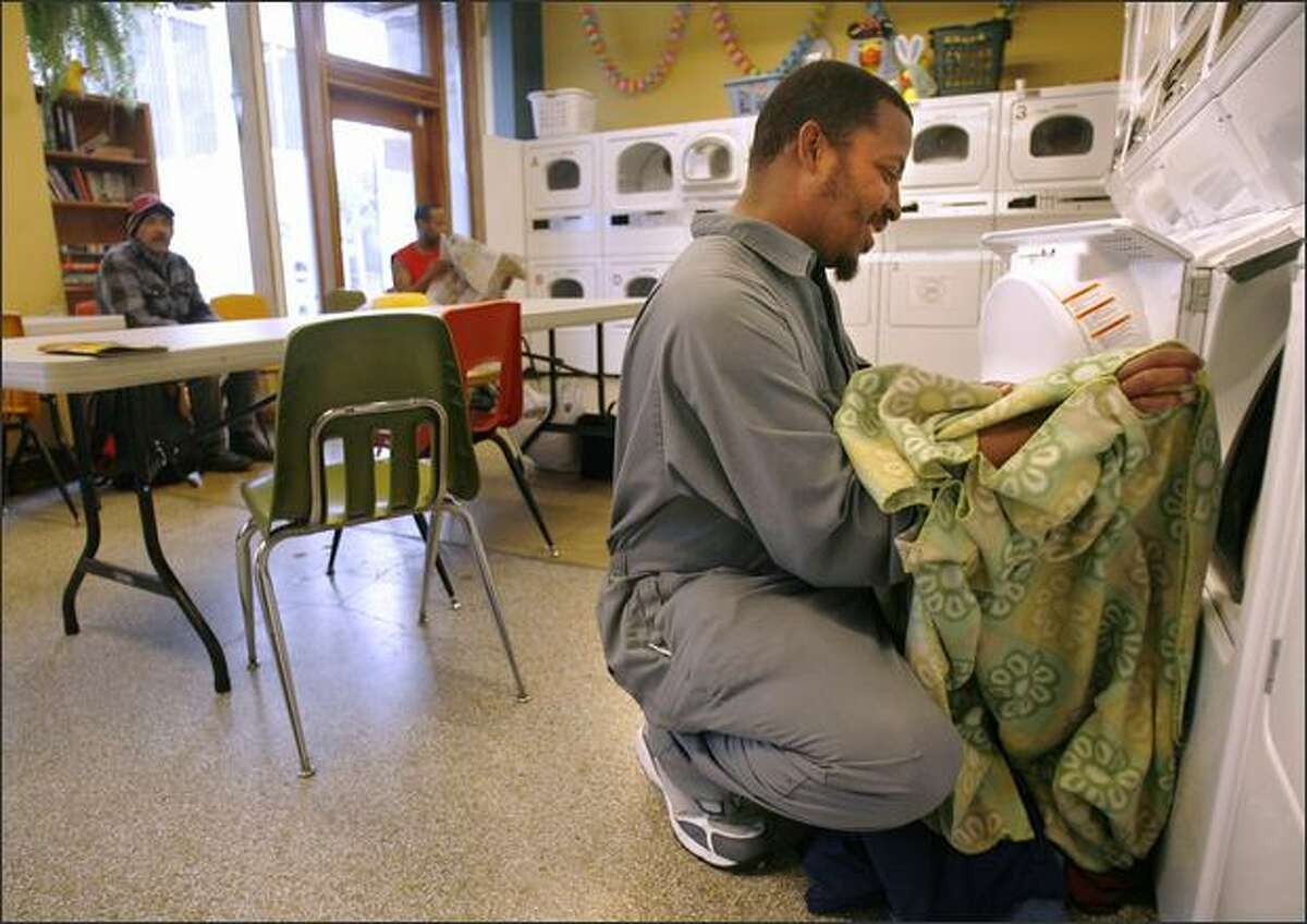 Darrell Williams does a load at Urban Rest Stop, which offers free laundry services, restrooms and showers to the homeless.