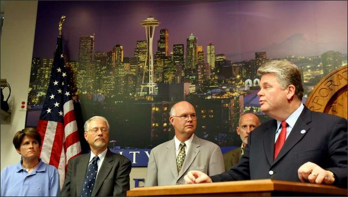 Mayor Greg Nickels, right, announces the settlement between the city and the Sonics while, from left, city council member Sally Clark, council president Richard Conlin and city attorney Thomas Carr look on Wednesday afternoon at City Hall.