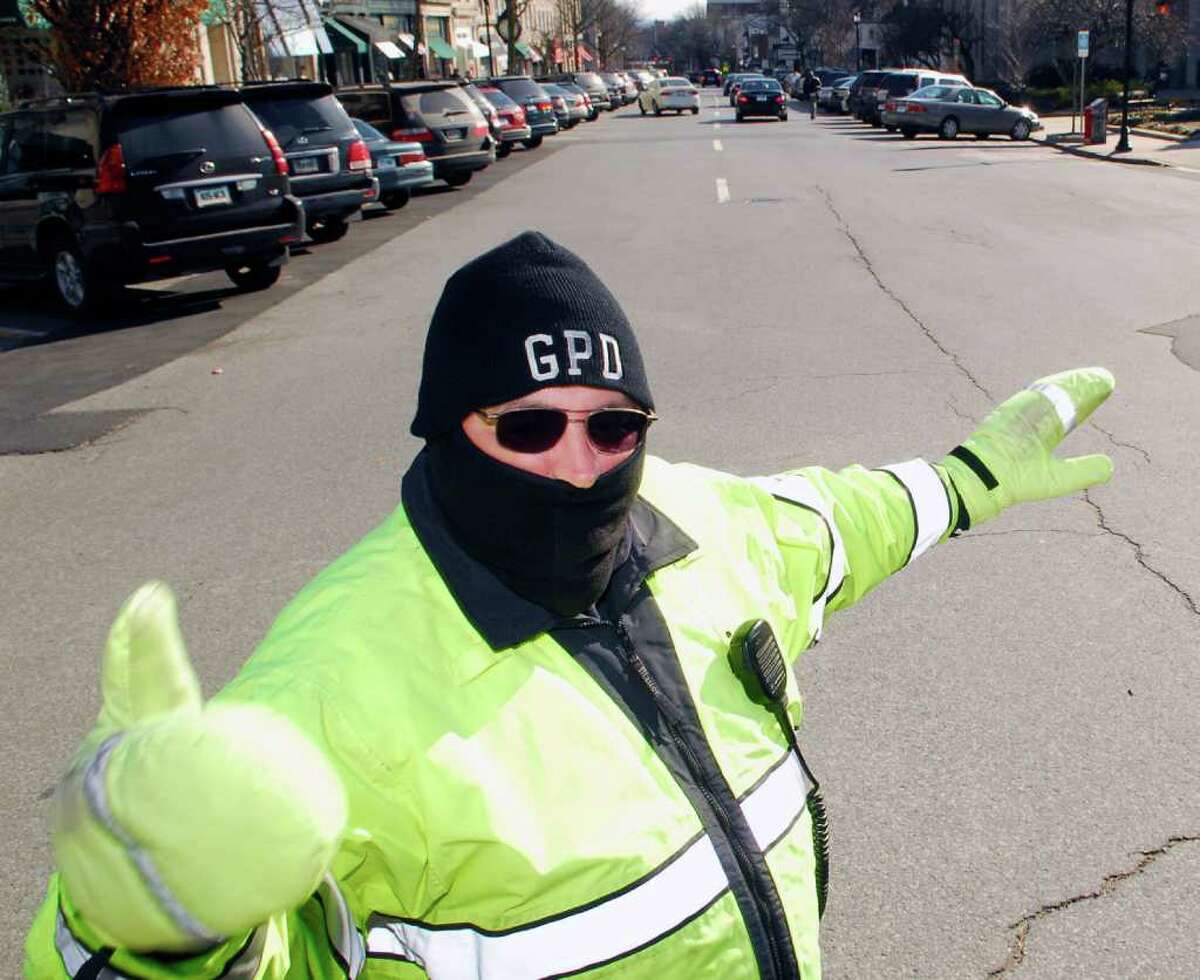 In this February 2008 file photo, Greenwich Police Officer James Genovese is bundled up for the cold as he directs traffic at the intersection of Greenwich Avenue, Arch Street and Havemeyer Place. Greenwich police are mourning the loss of one of their own after veteran officer Genovese died suddenly in the Westchester County (N.Y.) Medical Center Tuesday night. Genovese, who became a staple of Greenwich Avenue, where he was often seen directing traffic, was 44. He was off duty at the time of his death.
