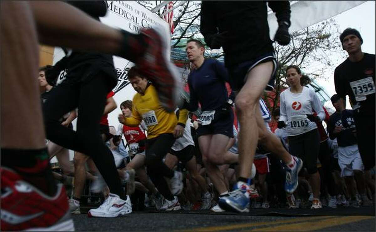 Competitors in the half-marathon start their race during Seattle Marathon events.