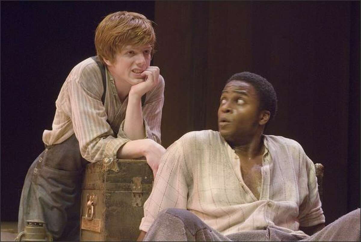 Robbie Fowler, left, cuts an impish figure as Huck, and Geoffery Simmons is a commanding presence as Jim in Taproot Theatre's "Big River: The Adventures of Huckleberry Finn."