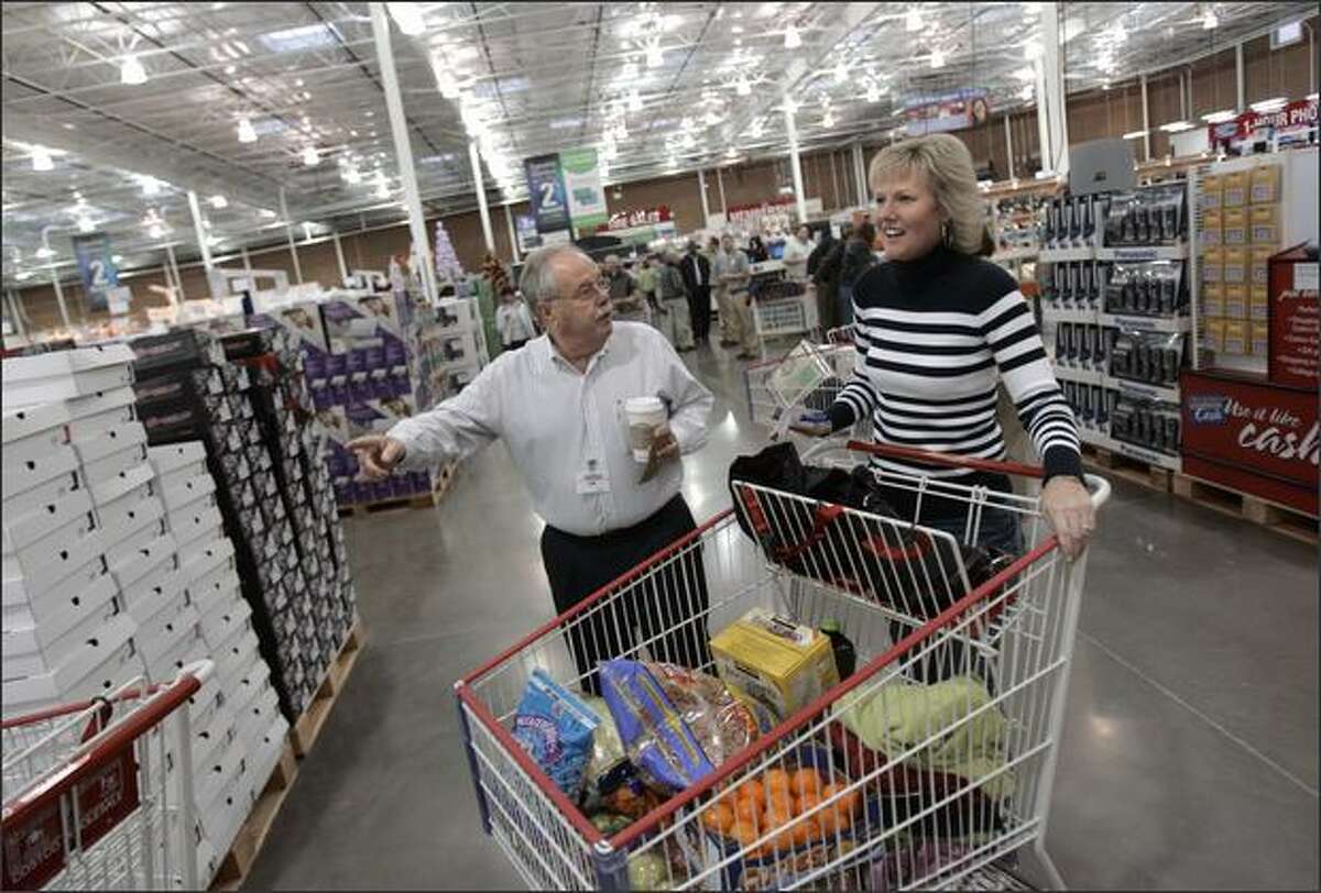 Costco CEO Jim Sinegal, above, is one of the defendants named in a shareholder lawsuit accusing Costco insiders of illegally backdating stock options. Sinegal is shown with shopper Brenda Hanson at the grand opening of the new Costco in Gig Harbor last November.