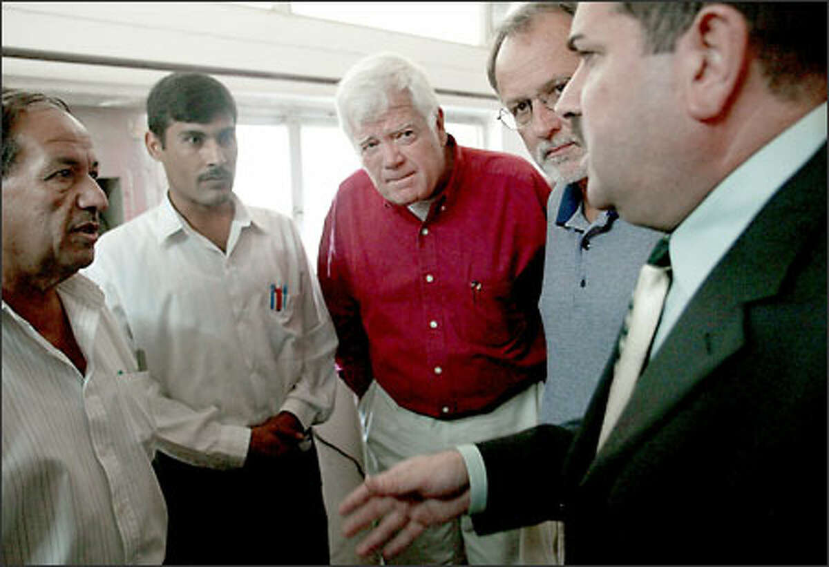 Reps. Jim McDermott, D-Wash., center, and David Bonior, D-Mich., second from right, listen to a plant manager at the water-treatment project in Rastama, Baghdad. Many treatment plants have not been repaired.