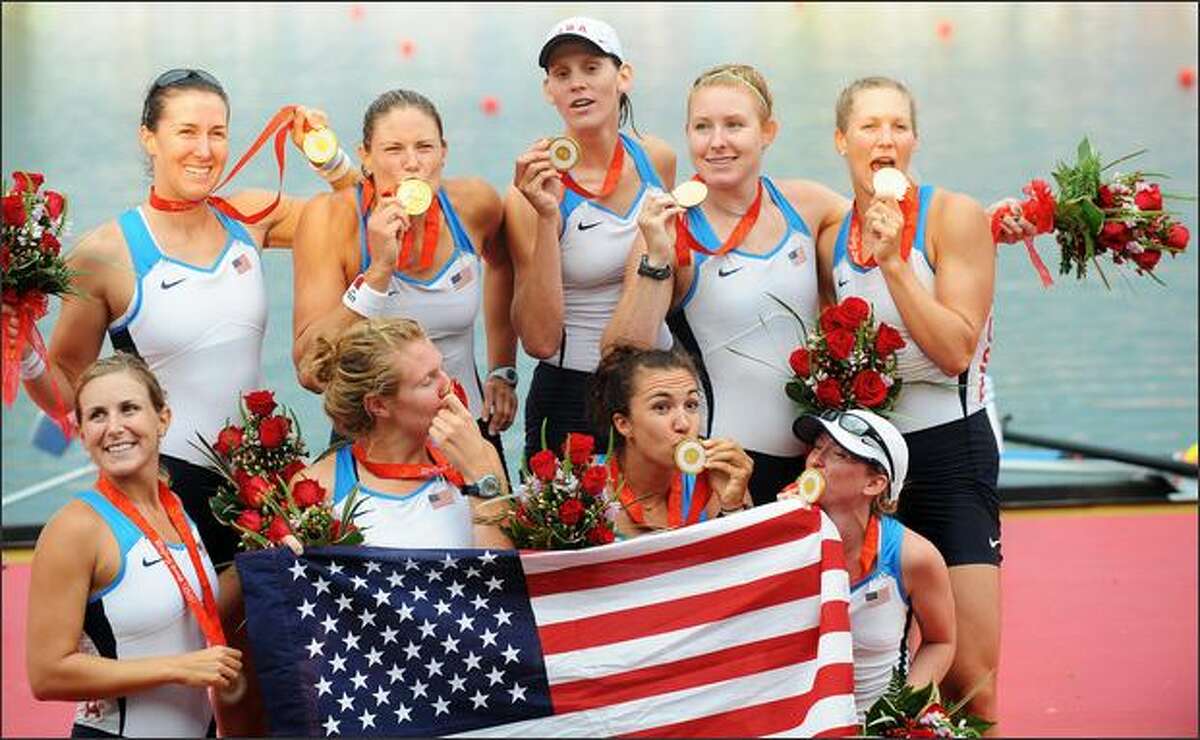 America's Erin Cafaro, Lindsay Shoop, Anna Goodale, Elle Logan, Anna Cummins, Susan Francia, Caroline Lind, Caryn Davies and Mary Whipple celebrate during the medals ceremony for the women's eight at the Shunyi Rowing and Canoeing Park in Beijing on Sunday. Cummins and Whipple rowed for the University of Washington. The U.S. won gold, Netherland Silver and Romania bronze. (Fred Dufour/AFP/Getty Images)