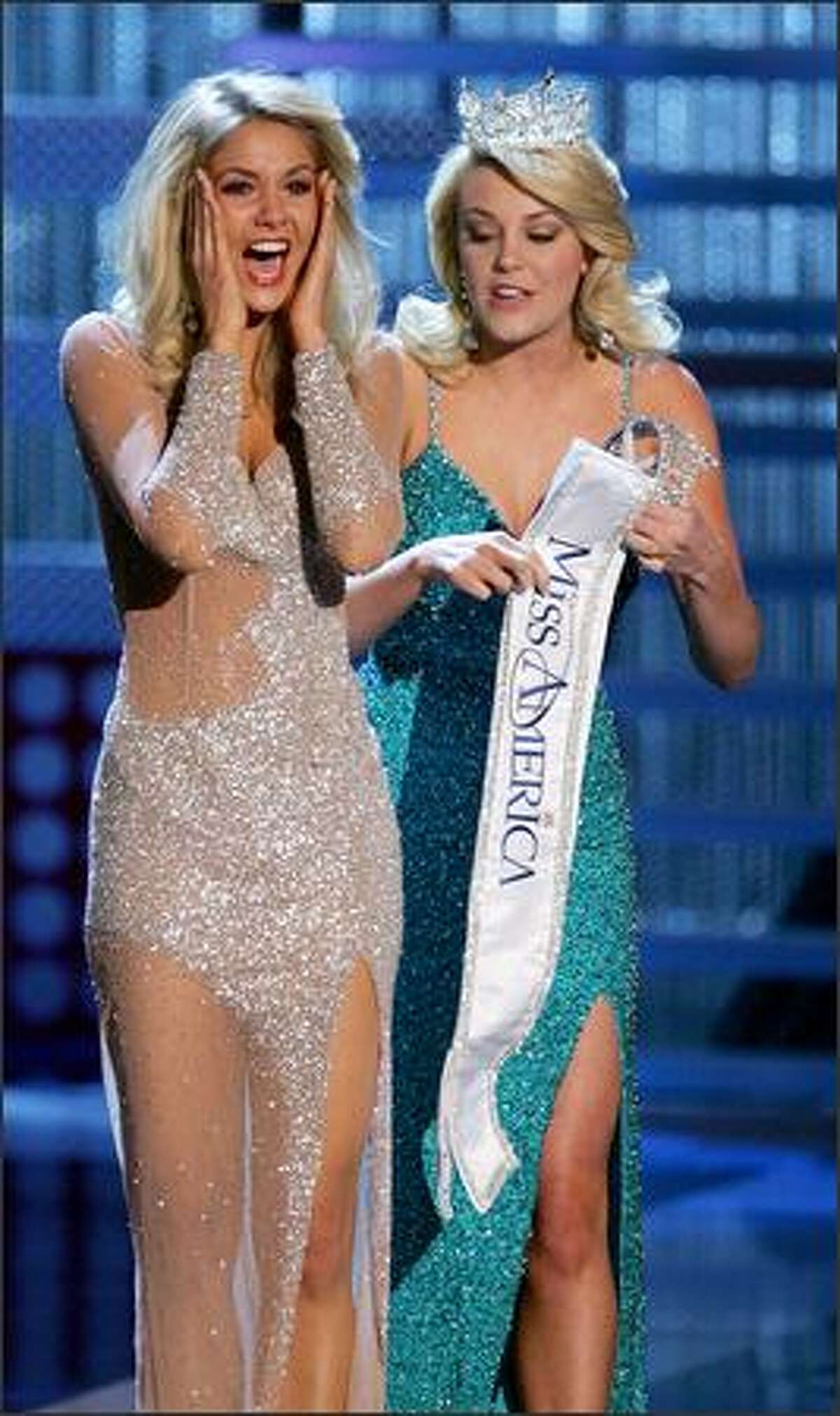 Miss America 2007 Lauren Nelson (right) gives the Miss America sash to Miss Michigan Kirsten Haglund.