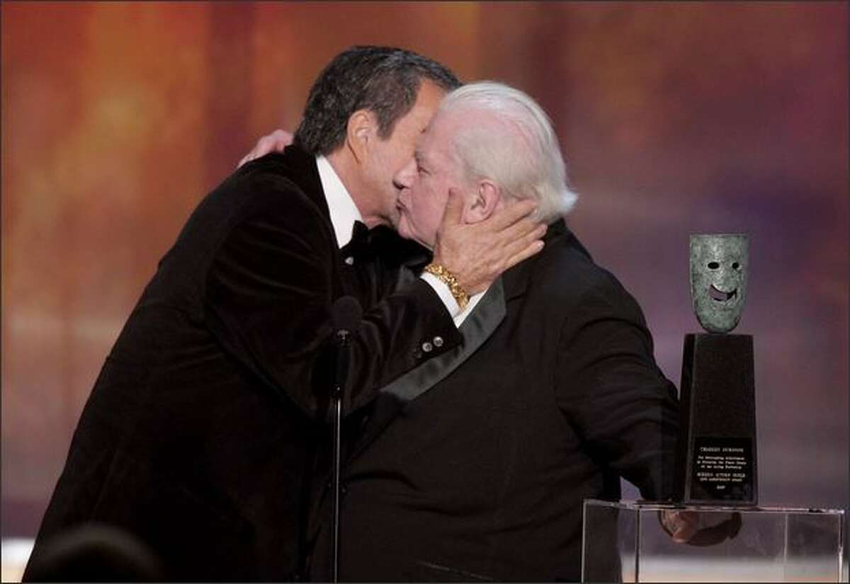Burt Reynolds, left, kisses Charles Durning, recipient of the 2007 Actors Guild Life Achievement Award, during the 14th annual Screen Actors Guild Awards.