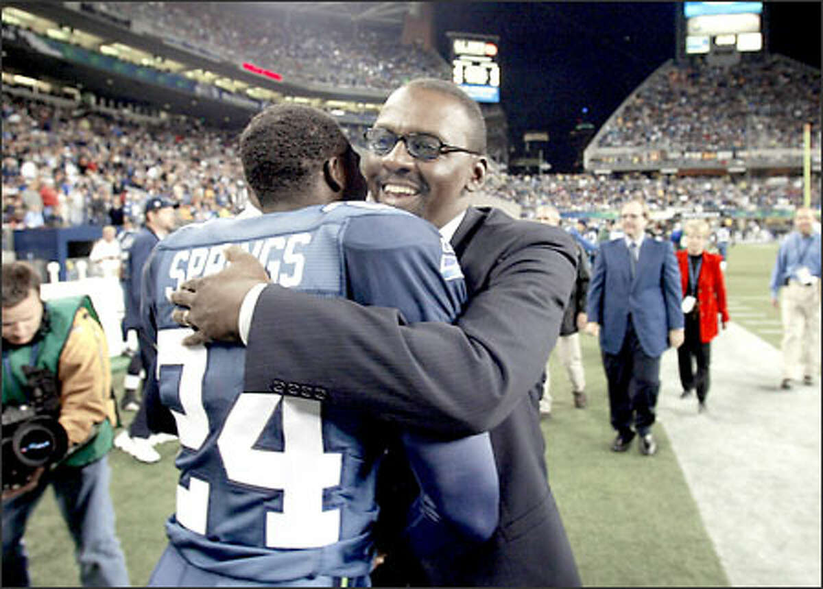 Kenny Easley and Seahawks cornerback Shawn Springs embrace after Easley became the seventh former Seahawks player selected to the team's Ring of Honor.