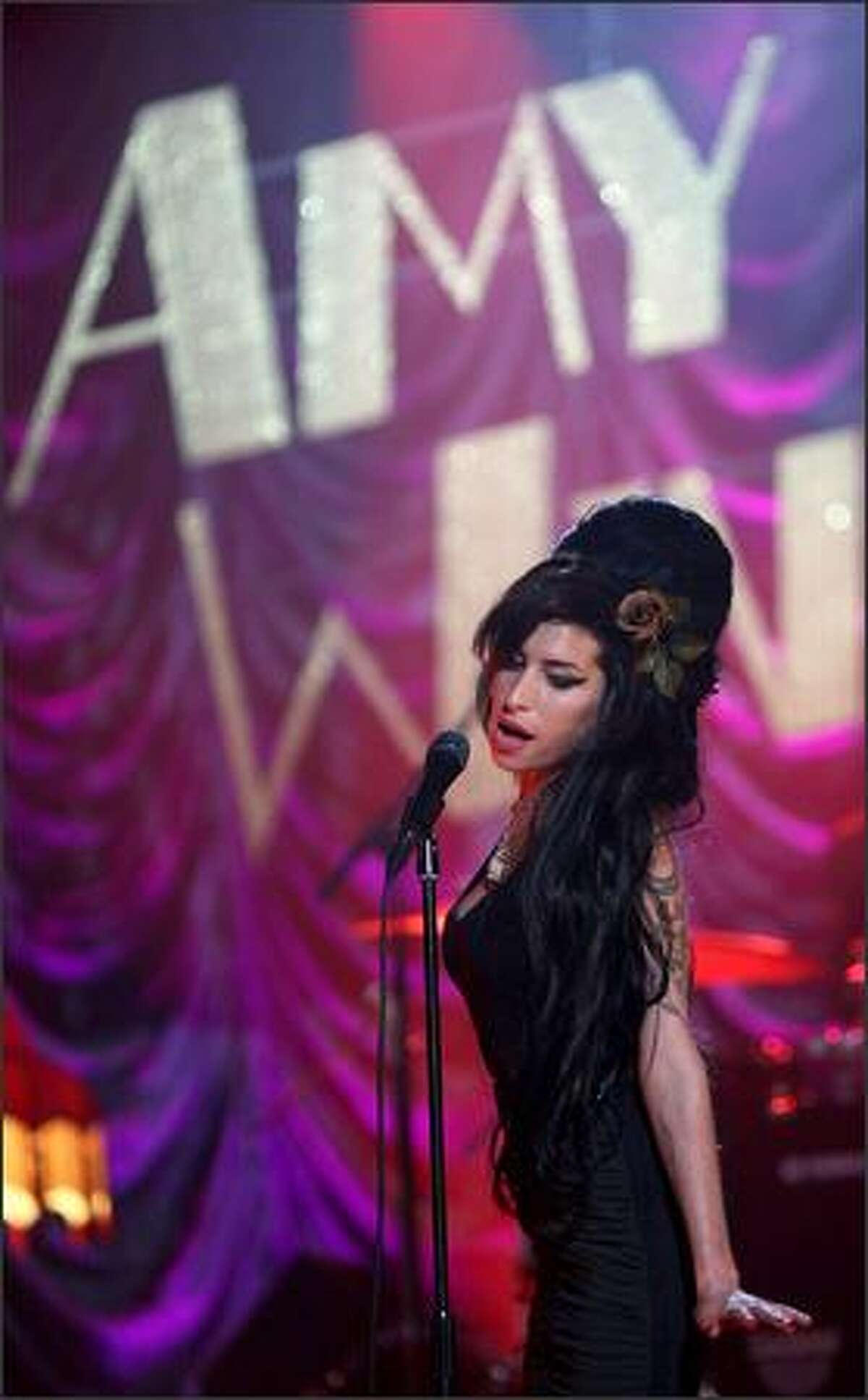 Amy Winehouse performs for the Grammy Awards via video link. Winehouse won five awards from her 6 nominations -- record of the year, best new artist, song of the year, pop vocal album and female pop vocal performance.