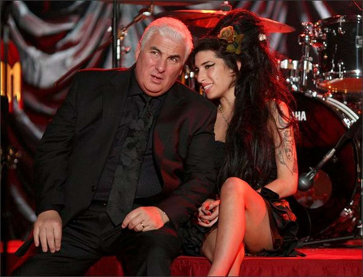 Amy Winehouse sits with her father Mitch as they await news of her Grammy Award.