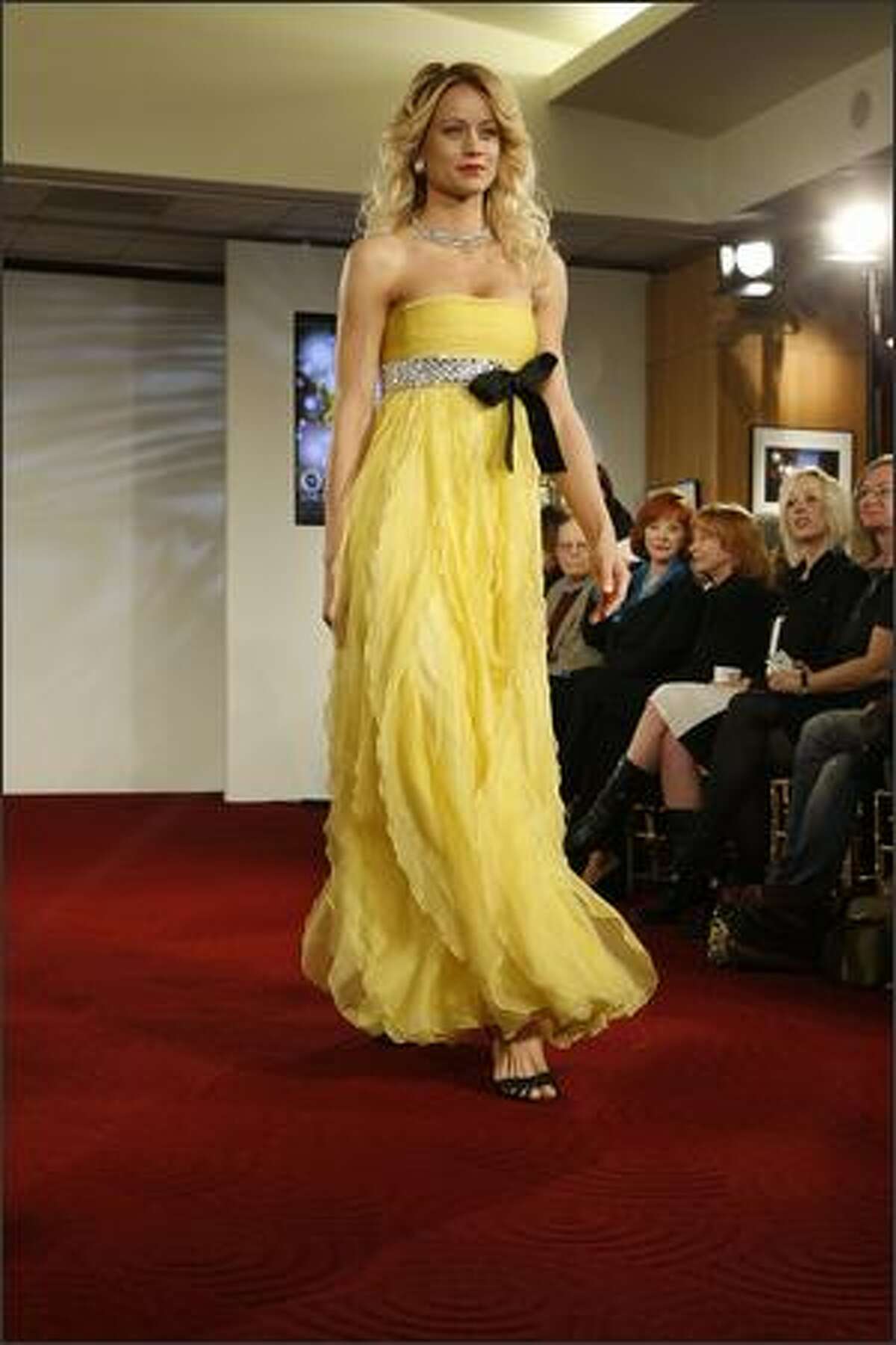 A model walks the runway at the Oscar Fashion Show at the Academy of Motion Pictures Arts and Sciences on Wednesday in Beverly Hills, Calif.