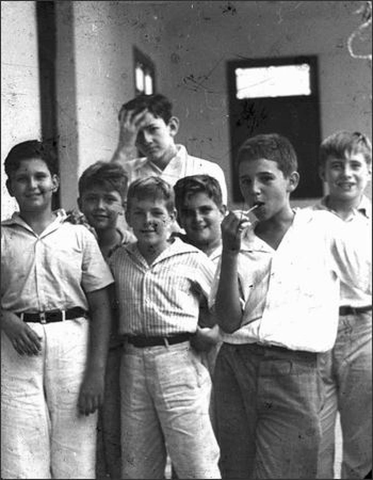 Fidel Castro, right, eats a lollipop in a 1940 photo taken of him and schoolmates when he was studying at the school Nuestra Senora de Dolores in Santiago de Cuba. The photo was taken by Spanish Jesuit Jose Maria Patac. JOSE MARIA PATAC/AFP/Getty Images