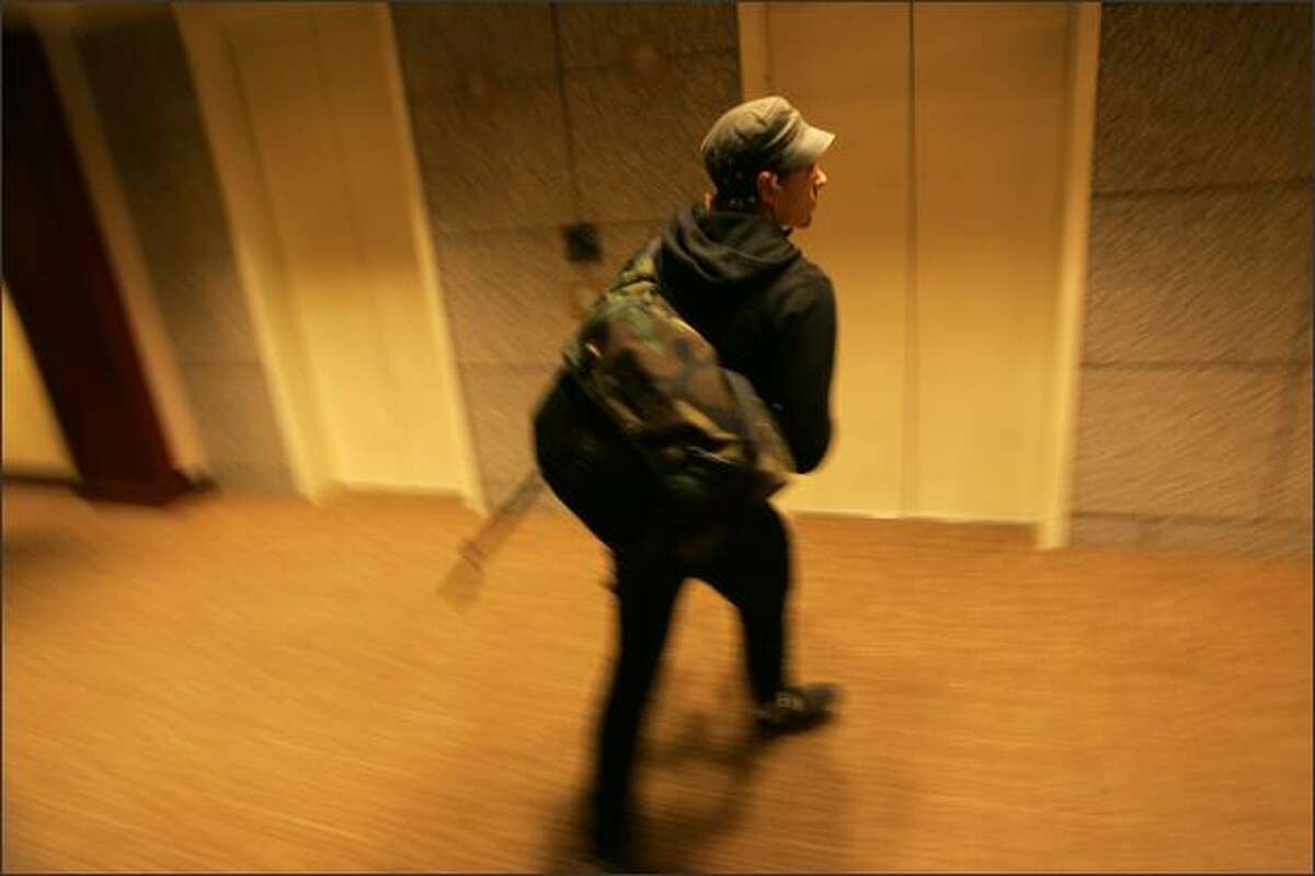 Bike messenger Ross Miller heads out of an elevator for a delivery in the US Bank Centre building in Seattle.