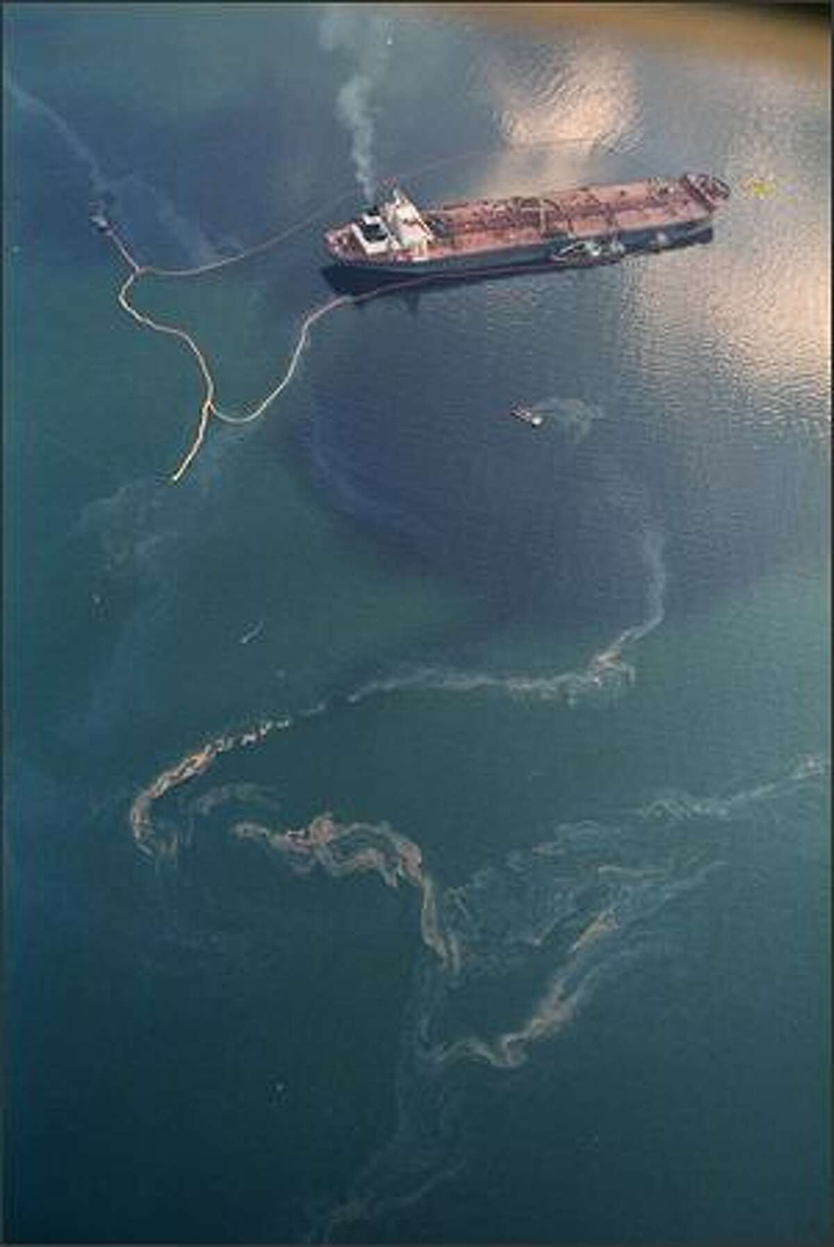 Crude oil from the tanker Exxon Valdez swirls on the surface of Alaska's Prince William Sound near Naked Island Saturday, April 9, 1989, 16 days after the tanker ran aground, spilling millions of gallons of oil and causing widespread environmental damage.