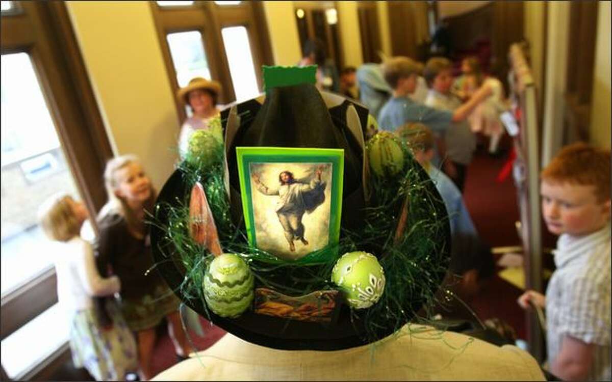 Steve Smith dons a hat inspired by Easter, St. Patrick's Day and Dr. Seuss in the hallway of the church prior to the start of mass.