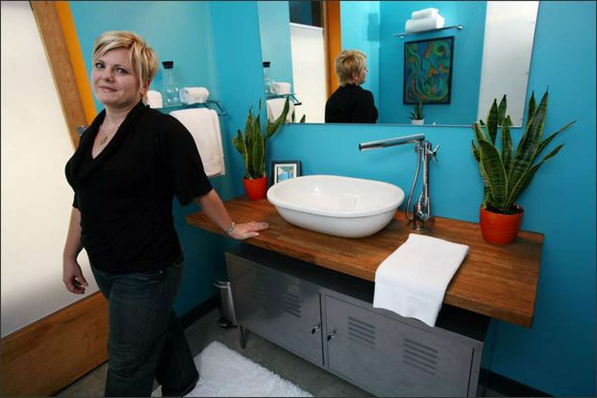 Lara Holland, at home in Mound, Minn. Holland takes IKEA furniture and repurposes it into other things, like the vanity/cabinet in her bathroom. Allen Brisson-Smith/The New York Times