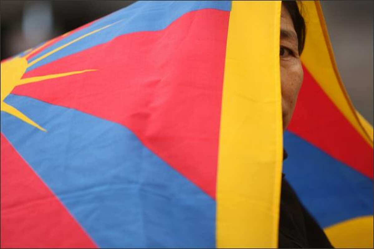 Nage Batui, of Seattle, joins other Tibet supporters during a candle light vigil at Westlake Plaza in Seattle on the declared world-wide day of Support for Tibet, the day that the Olympic Torch arrives in Beijing. The event was sponsored by the Tibetan Association of Washington.