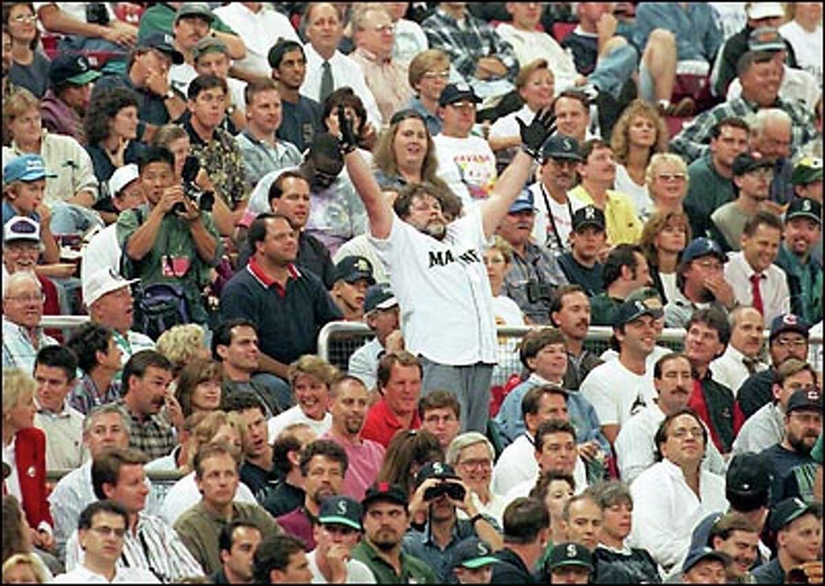 The most famous fan of all must be Bill the Beer Man. A one-time Kingdome concession vendor, he earned a place in our hearts by leading thousands of spectators in rousing stadium-wide cheers during Seahawks games. He's shown here trying to stir up the crowd at a Mariners game against the California Angels Sept. 26, 1995.