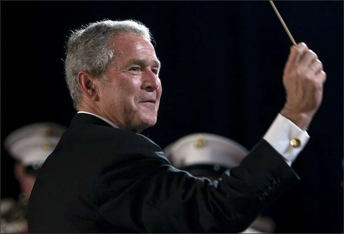 President George W. Bush conducts the Marine Corps Band during the White House Correspondents' Association Dinner at the Washington Hilton April 26, 2008 in Washington, DC.