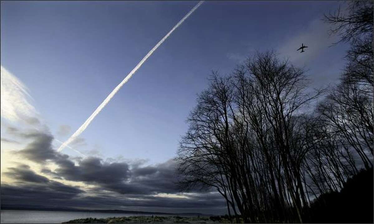 A contrail and jet seen from Golden Gardens Park in Seattle.