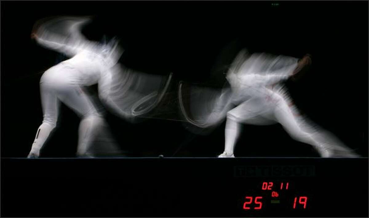 (1) Imke Duplitzer, of Germany, left, competes against, Danuta Andrezejuk, of Poland, in the bronze medal match in the Women's Team Epee at the 2008 FIE World Championships at the Fencing Hall, Saturday, April 19, 2008, in Beijing. (AP Photo/Robert F. Bukaty)