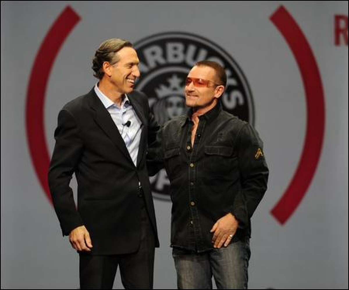 Rock star Bono's appearance, with Starbucks Chief Executive Howard Schultz, was kept secret from everyone, including his band.
