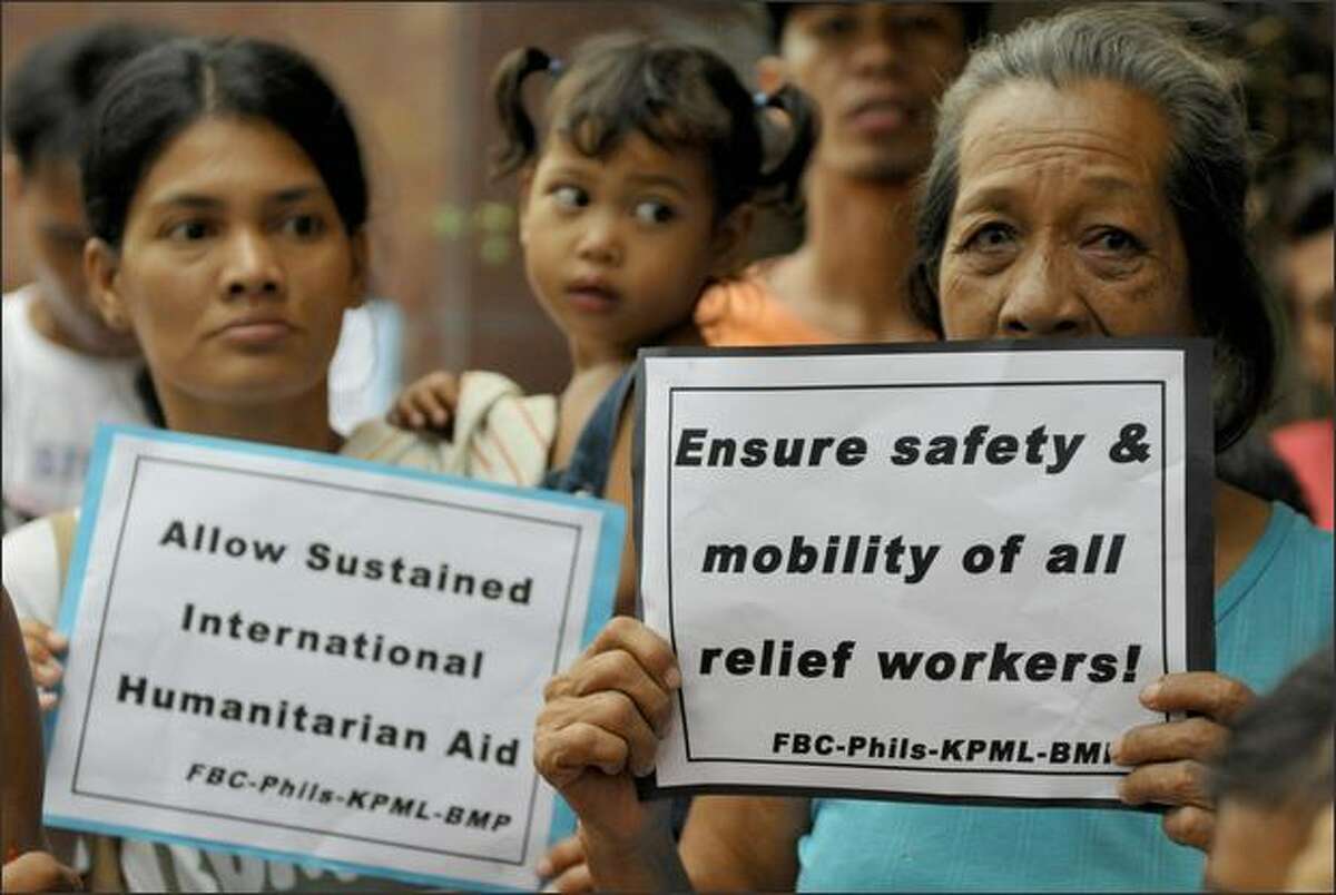 Protesters demonstrate outside the Myanmar embassy in Manila to urge the ruling junta to allow outside help for survivors of Cyclone Nagris. The cyclone slammed in the southern coast of Myanmar on May 3, 2008, leaving at least 22,000 people dead and another 41,000 missing by the official count, with the toll widely expected to rise. AFP PHOTO/Jay DIRECTO
