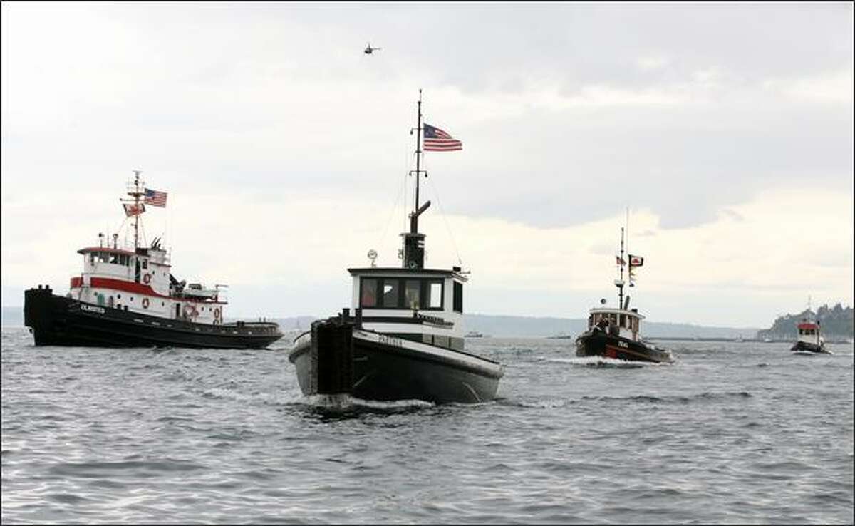 The Olmsted (left) managed to pass the Parthia to win the Class C classic tug boat race on Elliott Bay at the Seattle Maritime Festival. The 565-horsepower Olmsted won with a time of 7 minutes and 44 seconds.