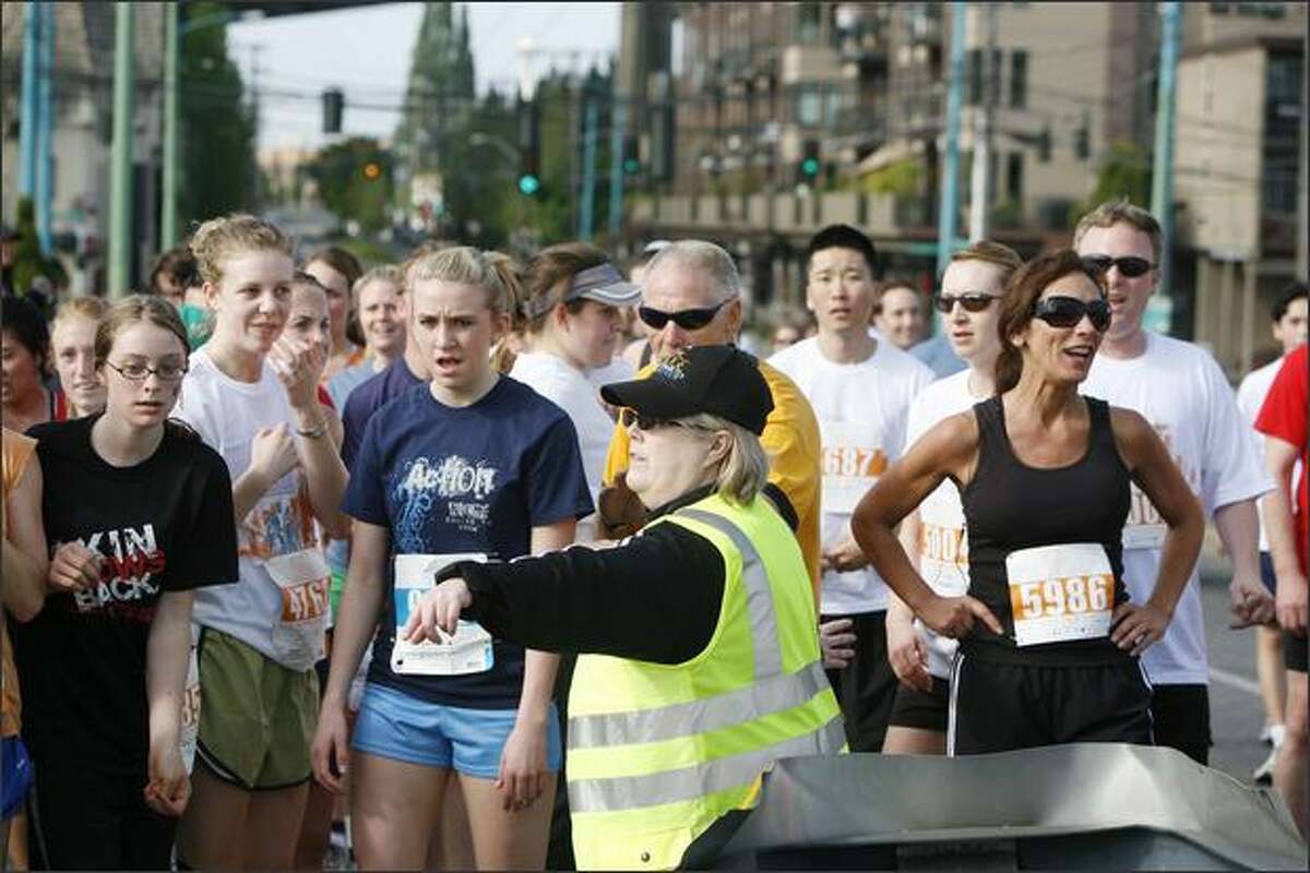 Disappointed runners are stopped by event staff as the University Bridge is raised during the Beat The Bridge 8K.