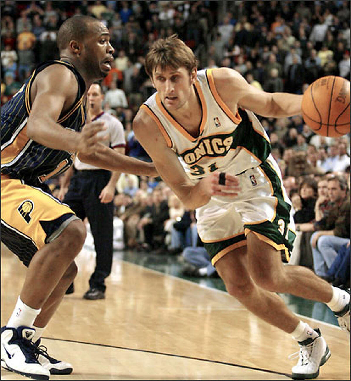 Sonics' Brent Barry dribbles past Pacers' Jamaal Tinsley.