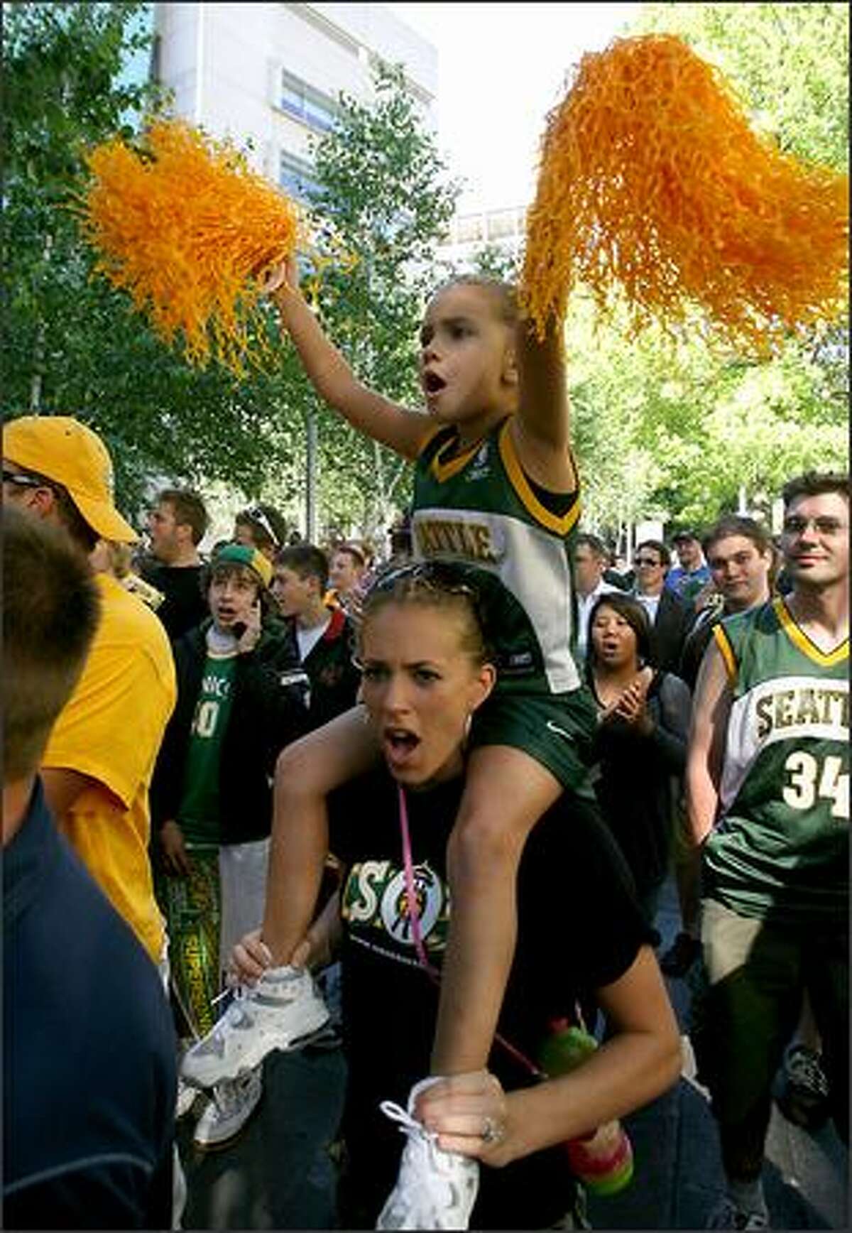 Seattle Sonics fans Rylee Reese, 5, and mother Emily Reese chant "Save Our Sonics," to show support for keeping the Sonics in Seattle.