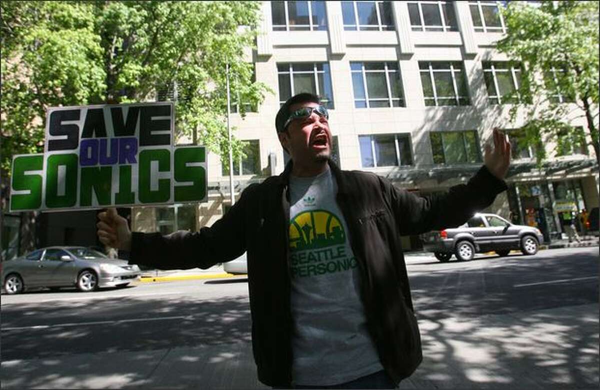 Seattle Sonics fan John Roberts chants "Save Our Sonics" to show support for keeping the Sonics in Seattle.