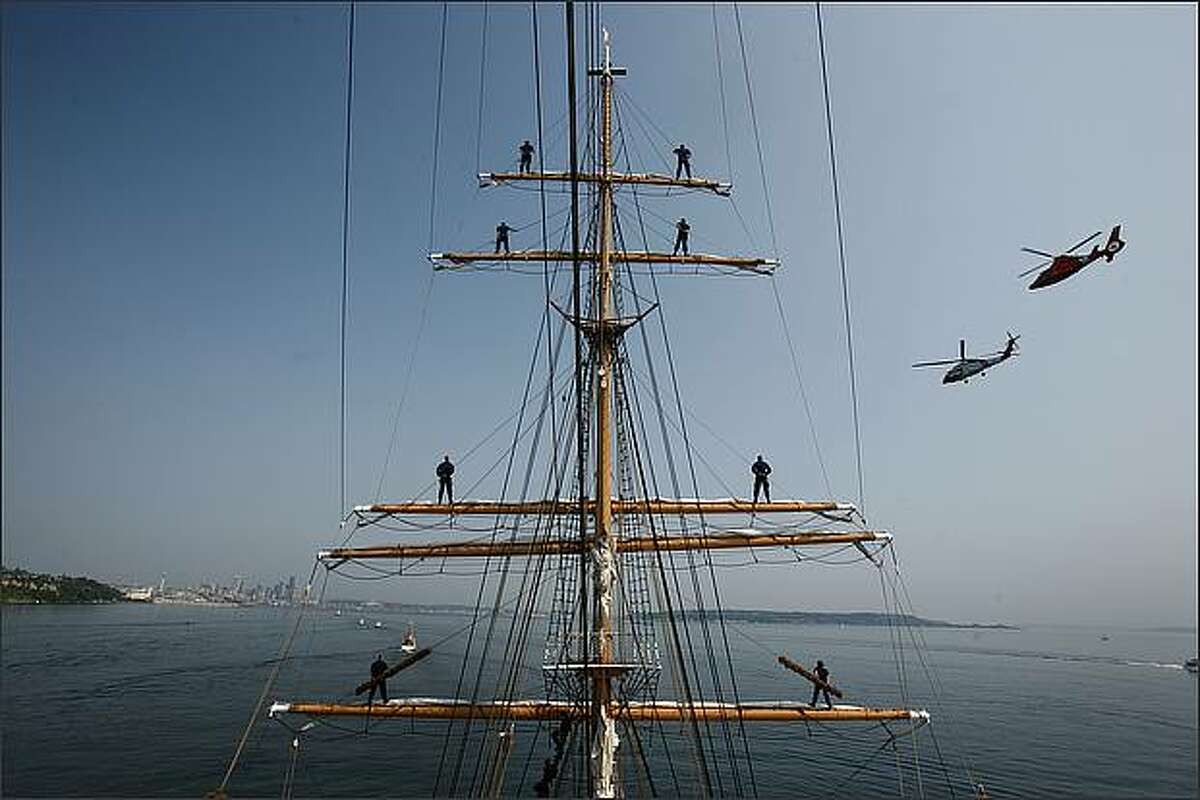 United States Coast Guard cadets stand at parade rest atop the mast of the U.S. Coast Guard Barque Eagle, a U.S. Coast Guard training vessel as the boat rounds West Point off of Magnolia. The boat, a former German boat, was taken as a war prize after World War II and is the only sailing vessel in the U.S. maritime services. The vessel is almost the length of a football field and carries 175 crew members.