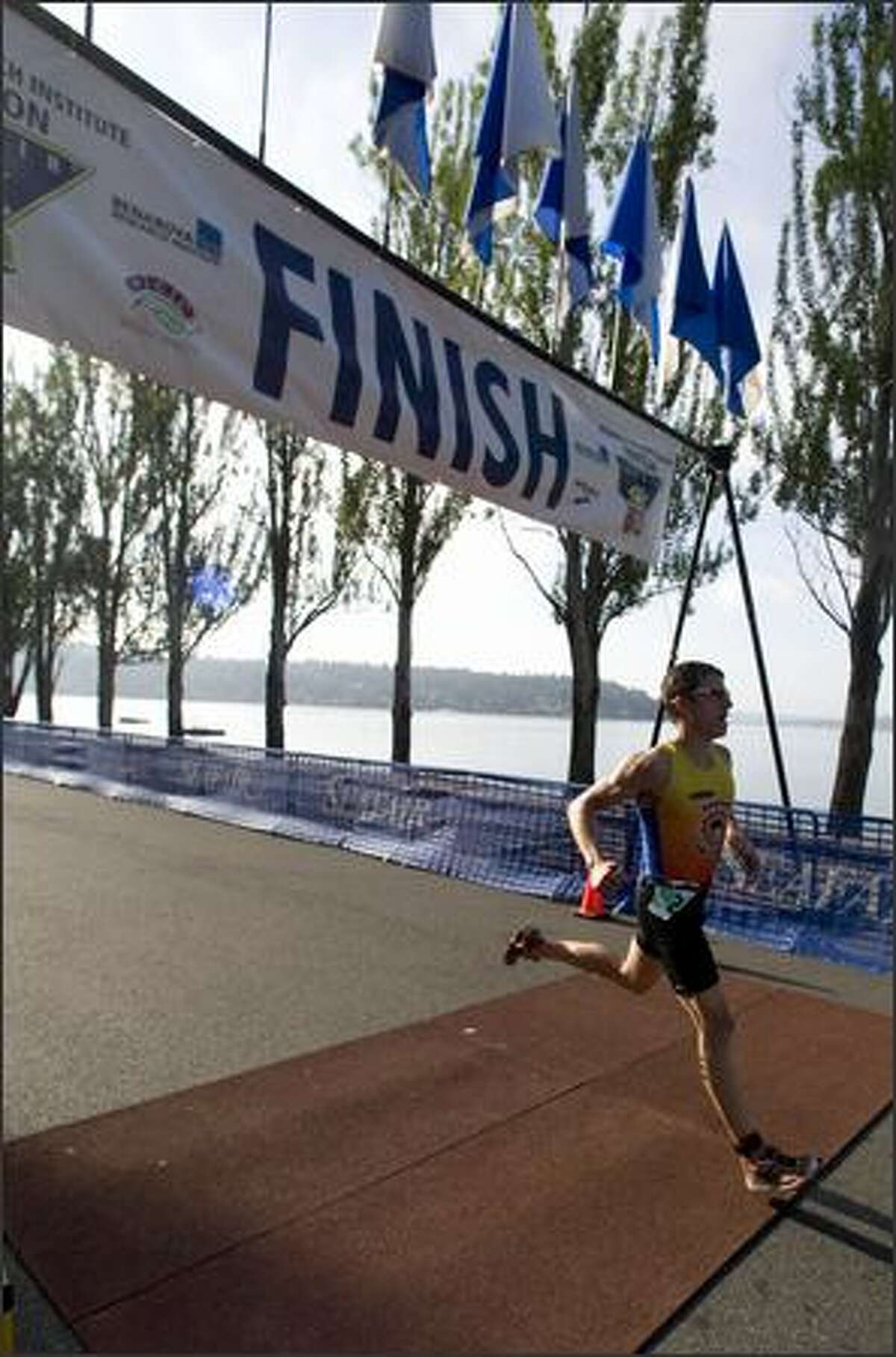 Chris Tremonte, of Redmond, crosses the finish line to place first with a time of 59.09 in the 2008 Benaroya Research Institute Triathlon.