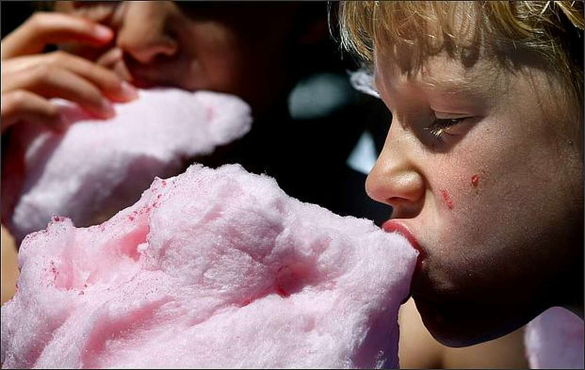 "Empty calories" are not likely on the minds of Hunter Hoye, 7, right, and his brother Dustin, 10, as they get sticky consuming cotton candy at the Seattle Center. While all of the calories in the longtime fair favorite come from sugar and are "empty," meaning they have little or no nutritional value, cotton candy actually contains only about 120 calories per wand -- less than a can of regular cola. July 25, 2008