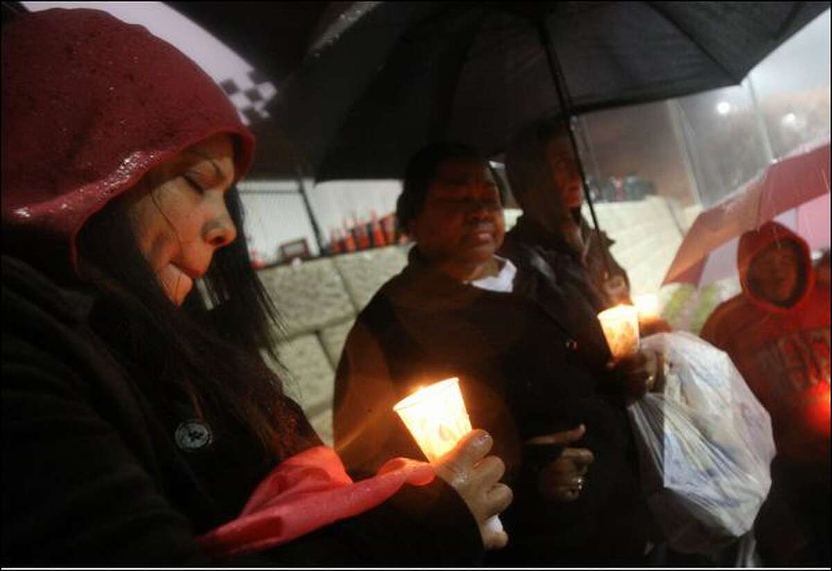 Liz Ali, left, the mother of Perry Henderson, who was shot and killed in January, attends a memorial last week at Garfield High School for Quincy Coleman, 15, who also died of gunshot wounds.