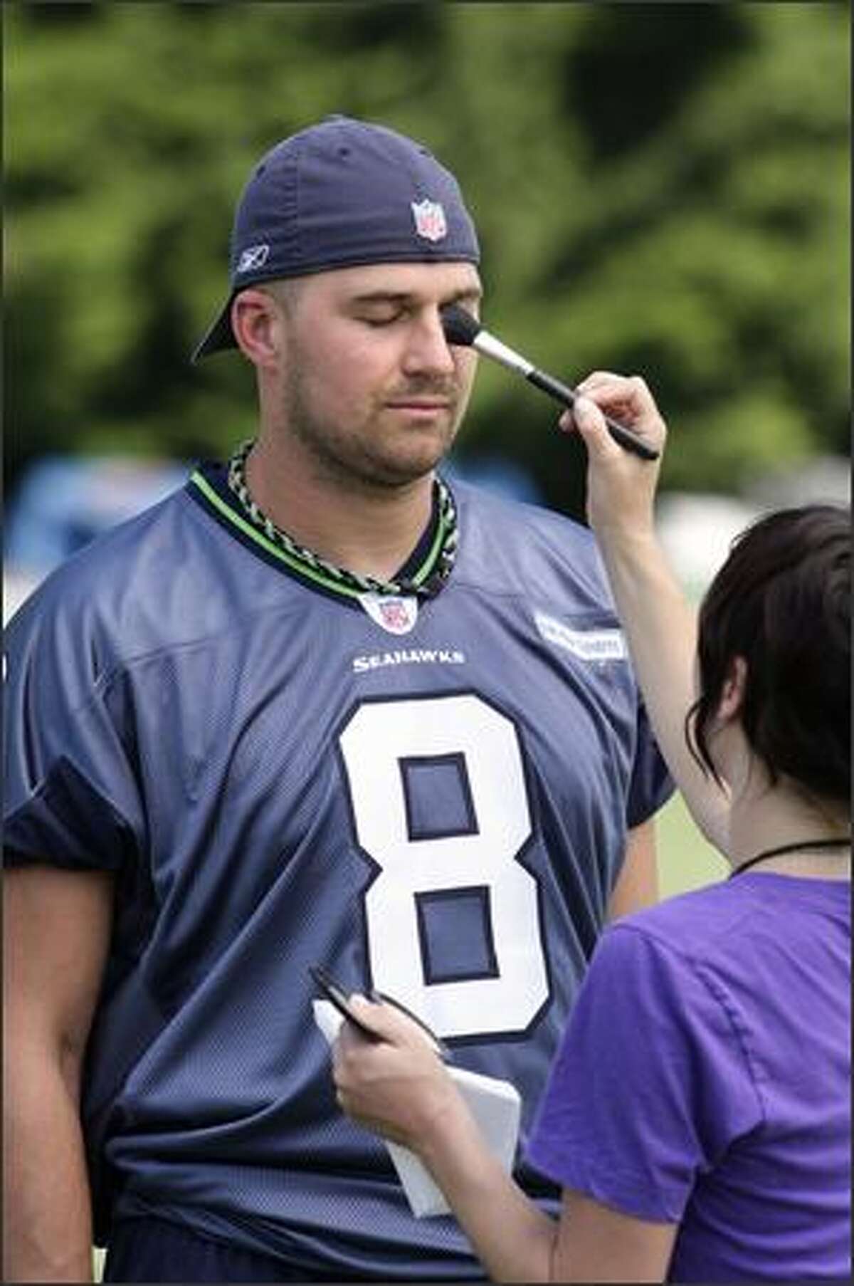 Quarterback Matt Hasselbeck has makeup applied prior to the photo shoot by artist Christine Cherbonnier.