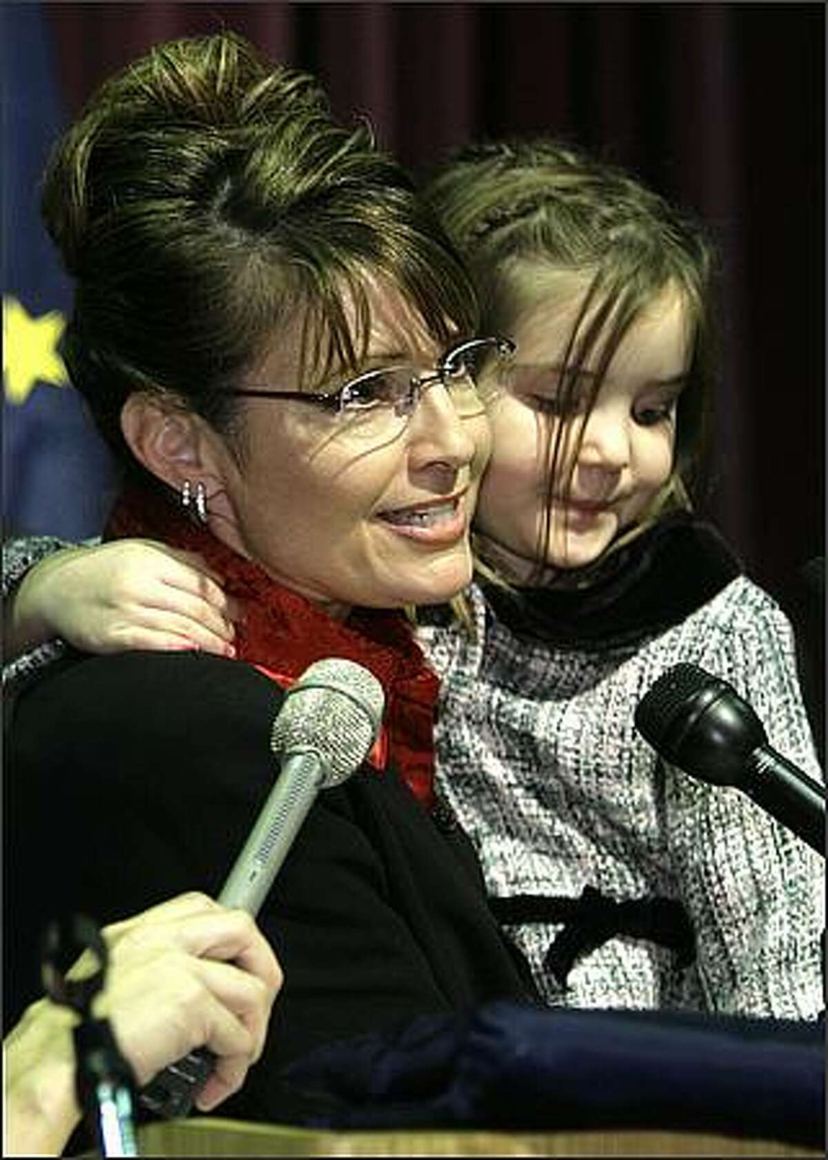 In this Nov. 8, 2006 file photo, then Governor-elect Sarah Palin holds her daughter Piper as she gives a victory speech in Anchorage, Alaska. John McCain tapped little-known Alaska Gov. AP Photo/Al Grillo