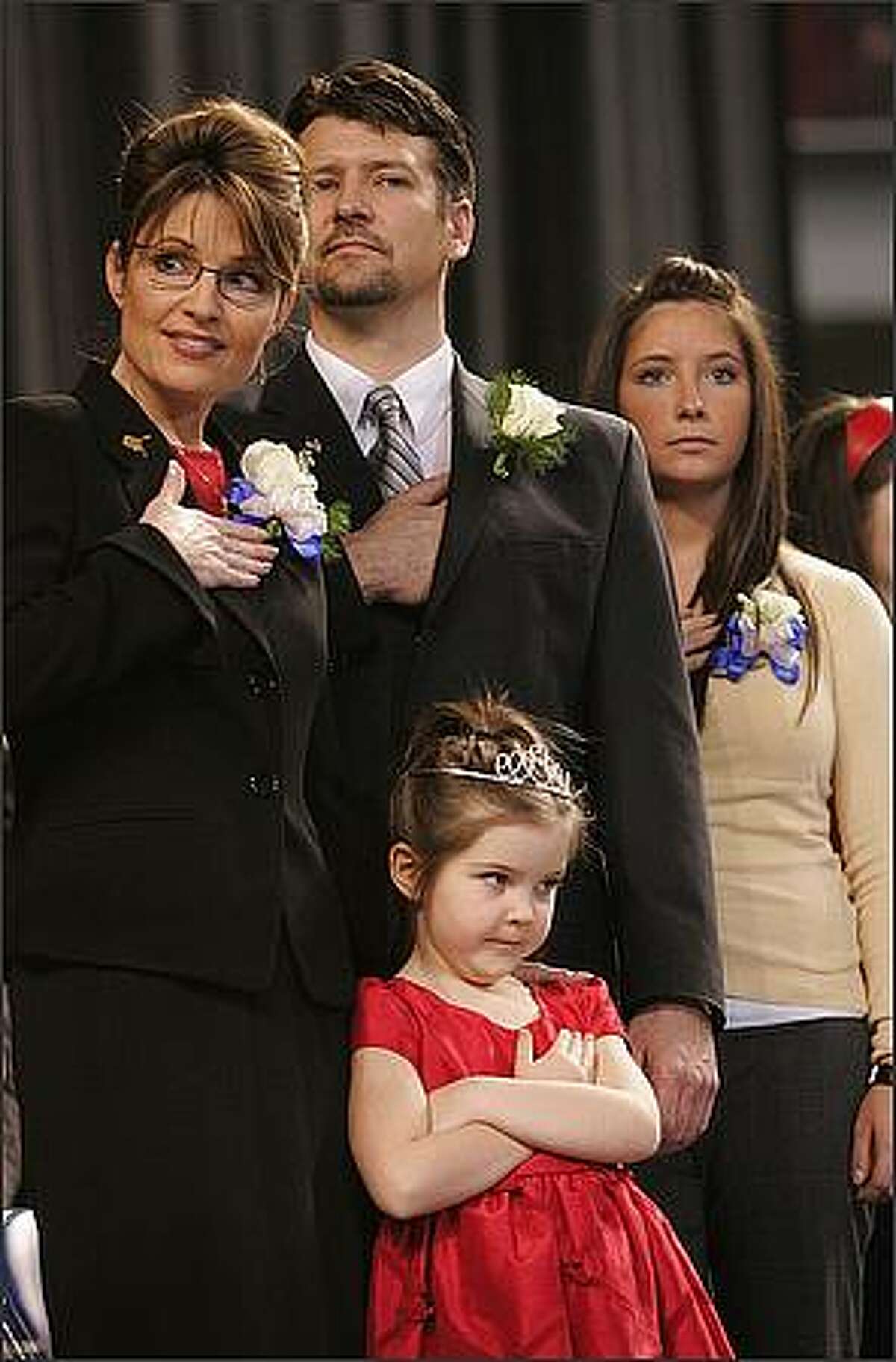 In this Dec. 4, 2006 file photo, Gov. Sarah Palin, left, her husband Todd, and daughters Bristol,16, right, and Piper, 5, front stand as the colors are retired at the end of an inauguration ceremony in Fairbanks, Alaska Palin, 42, is the first female and youngest governor of Alaska. AP Photo/Al Grillo