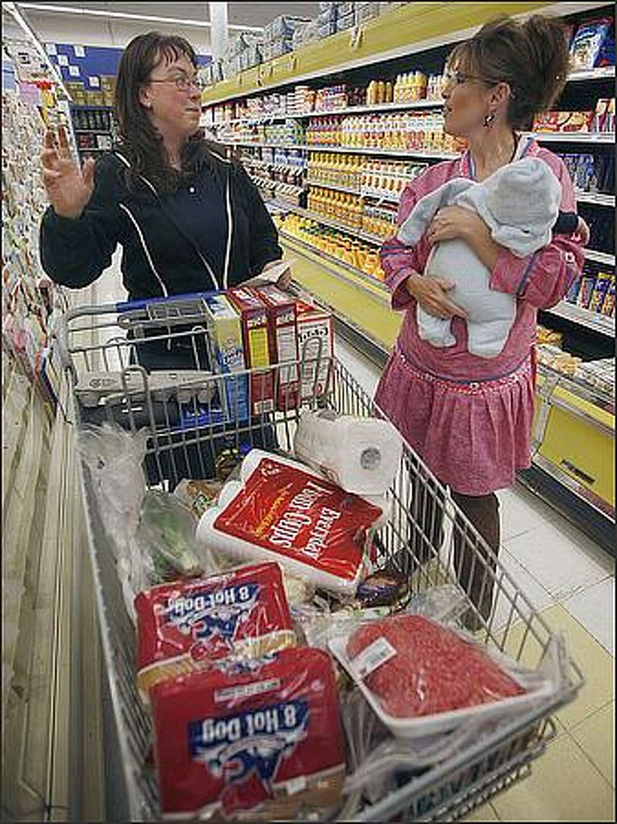 In this Monday, June 30, 2008 file photo, Laurie Serino, left, talks about the high food prices with Alaska Gov. Sarah Palin in Barrow, Alaska. AP Photo/Al Grillo